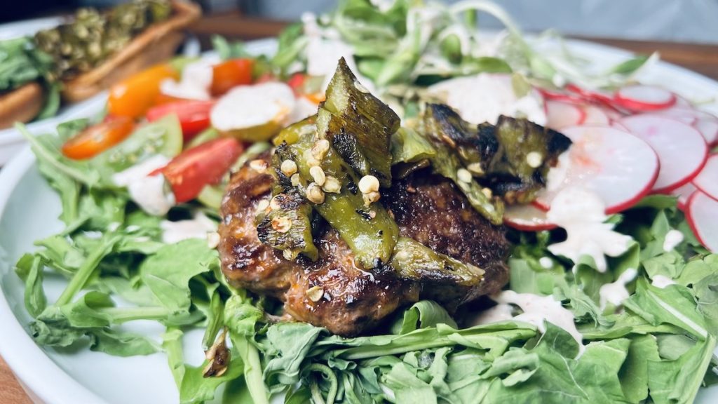Green Chile Burgers Salad topped with Tajin Sour Cream