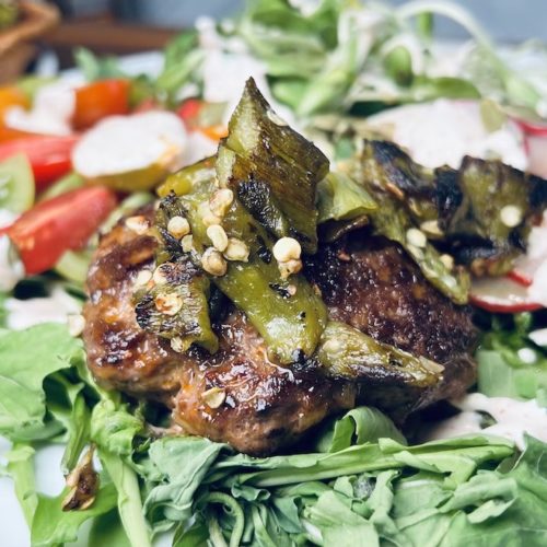 Green Chile Burgers Salad topped with Tajin Sour Cream